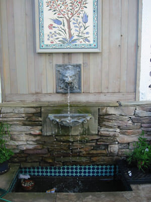 Custom water feature using tile acquired by homeowner in Italy.