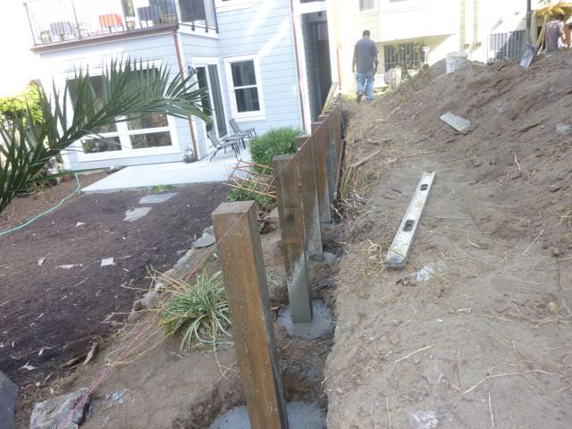 Foundation Posts in well of retaining wall 