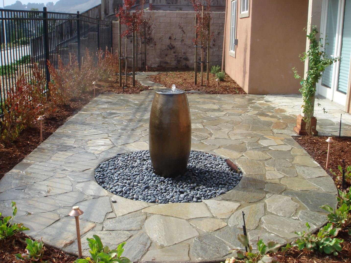 stone patio construction with vase fountain