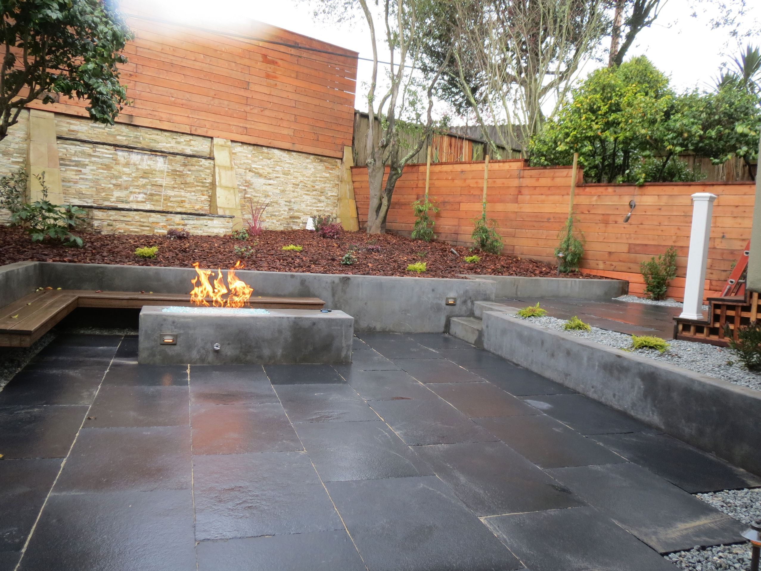 custom stone patio with gas fire pit