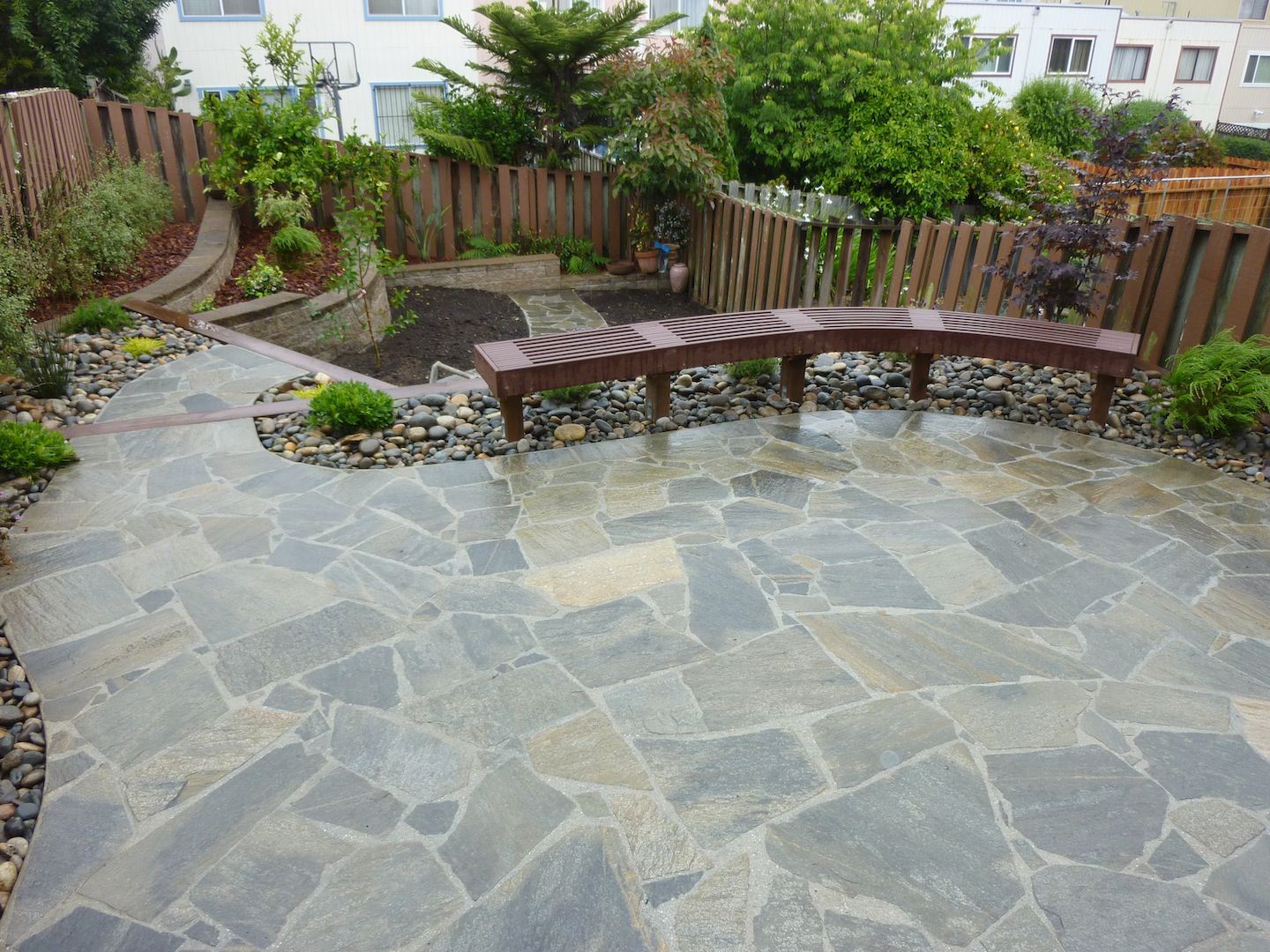 custom patio construction with retaining wall and bench