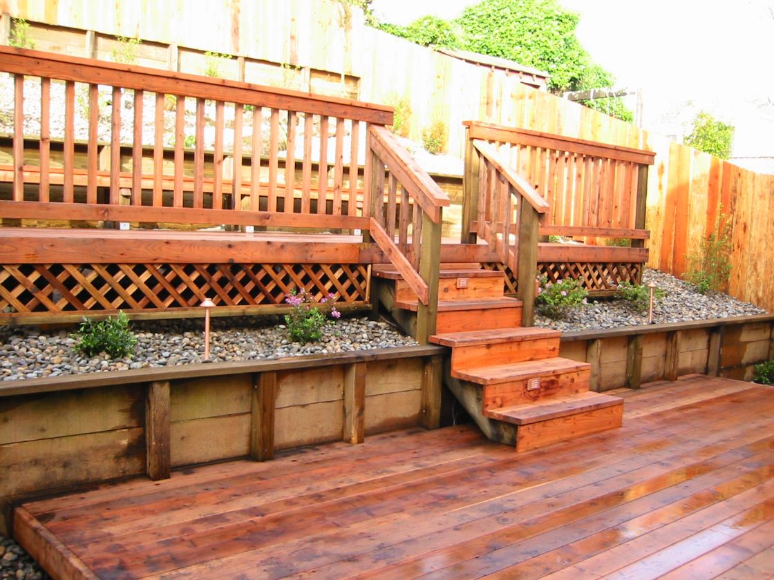 custom constructed wooden deck and patio with staircase
