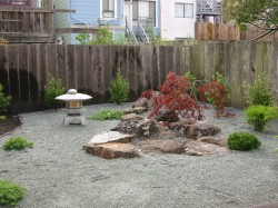 Dry creek with decomposed granite ground cover and lantern