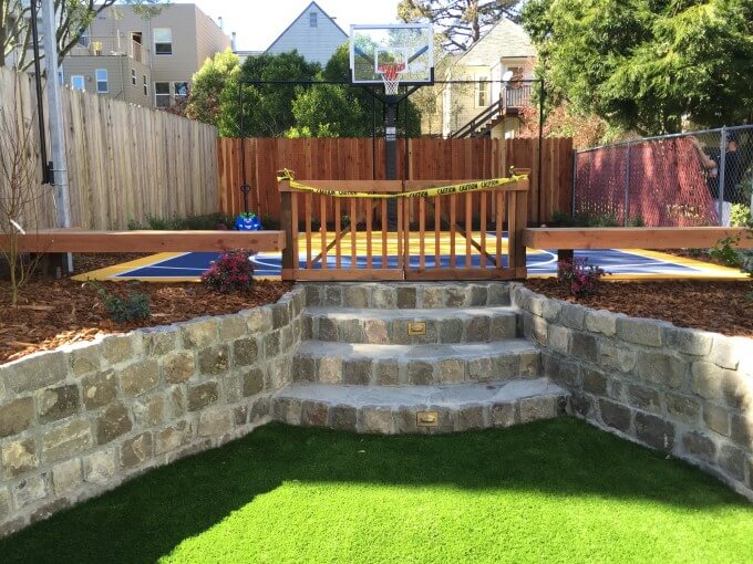 Sports backyard: basketball court has benches to watch the game play, as well as halogen lights