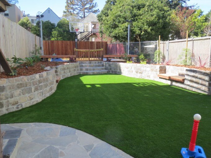 The finished backyard landscaping project: sports centered, with strong turf, basketball court and room for soccer