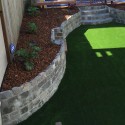Artificial turf, retaining wall and mulch protected plants