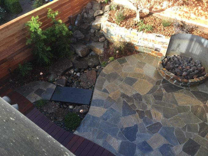 custom stonework patio, path, and bridge, designed and installed by Tamate Landscaping