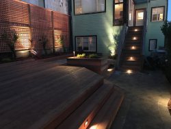Backyard Landscape Project: View of deck, lattice and stair lighting from the path
