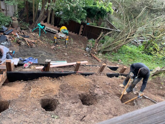 Digging 3.5 feet holes for retaining wall posts at Ashbury Height project.