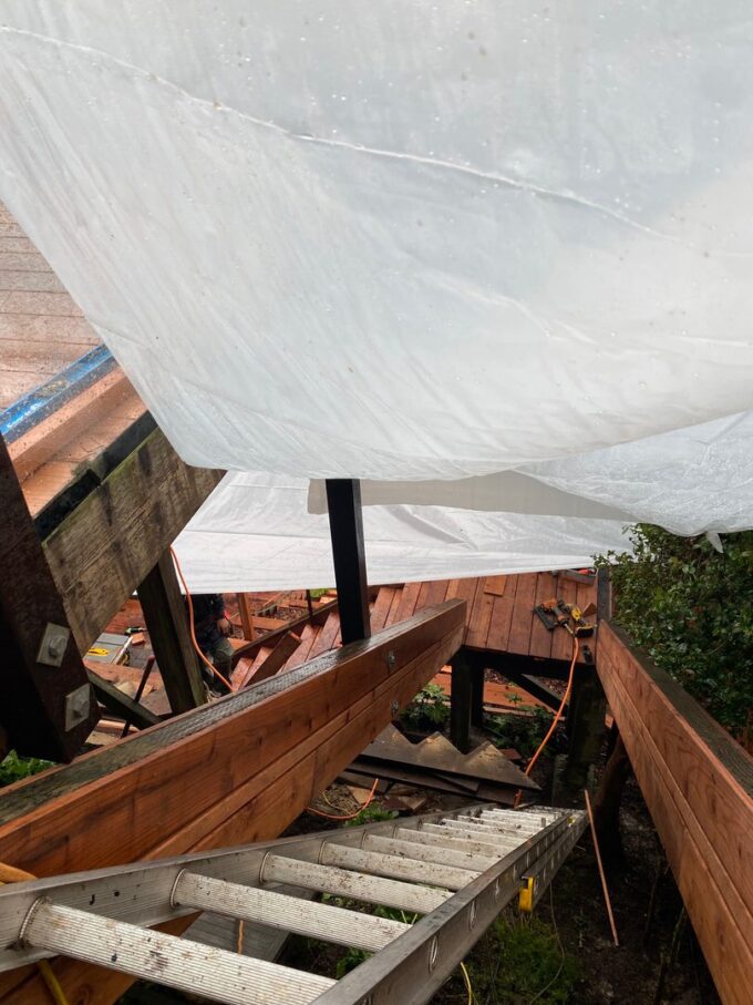 Tarp covering used during atmospheric river at Ashbury Height project. Tarp covers stairs installation area in progress.