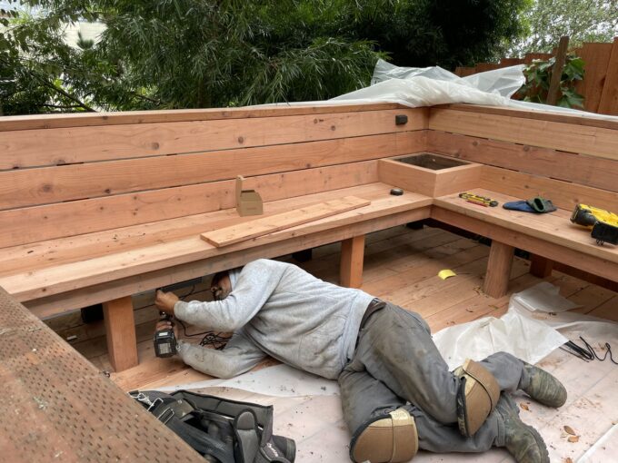 Lights being installed by lead project manager under custom made bench at Ashbury Heights project