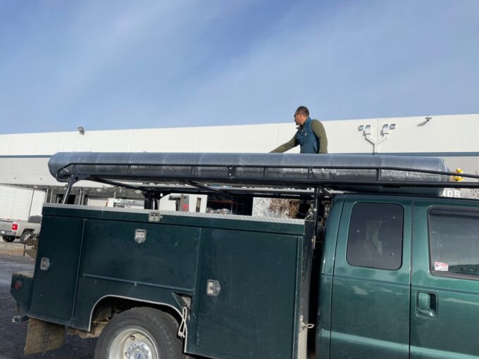 Paul on truck with loaded artificial turf on green truck at Global Sun-Turf in Hayward, CA.