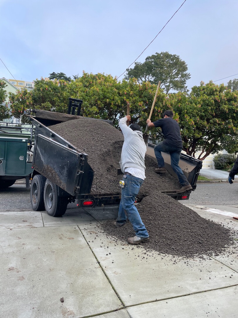 Unloading five tons of base rock from trailer for Sunnyside, San Francisco project.