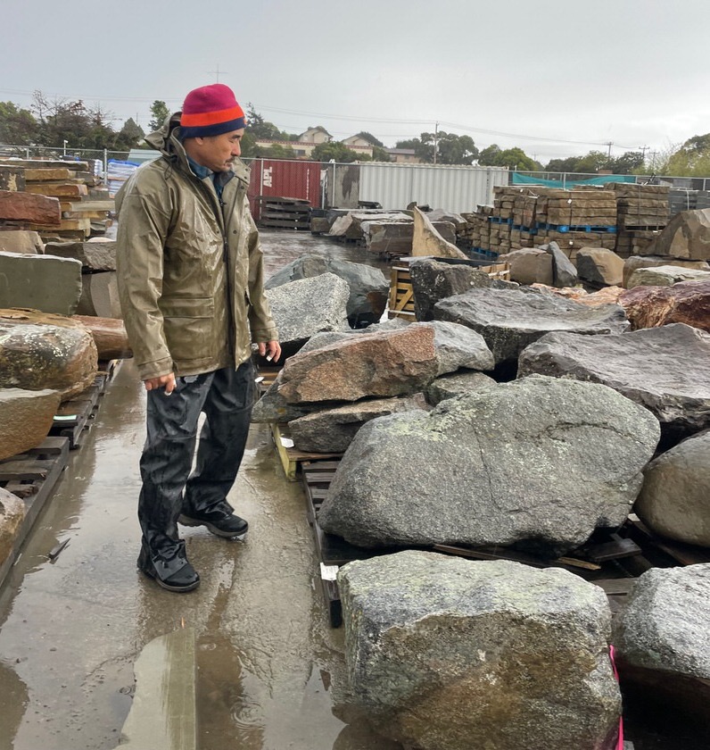 Paul carefully selecting boulders at American Soil and Stone