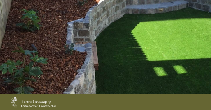 Artificial Turf, Retaining Wall, And Mulch-protected Plants As An 