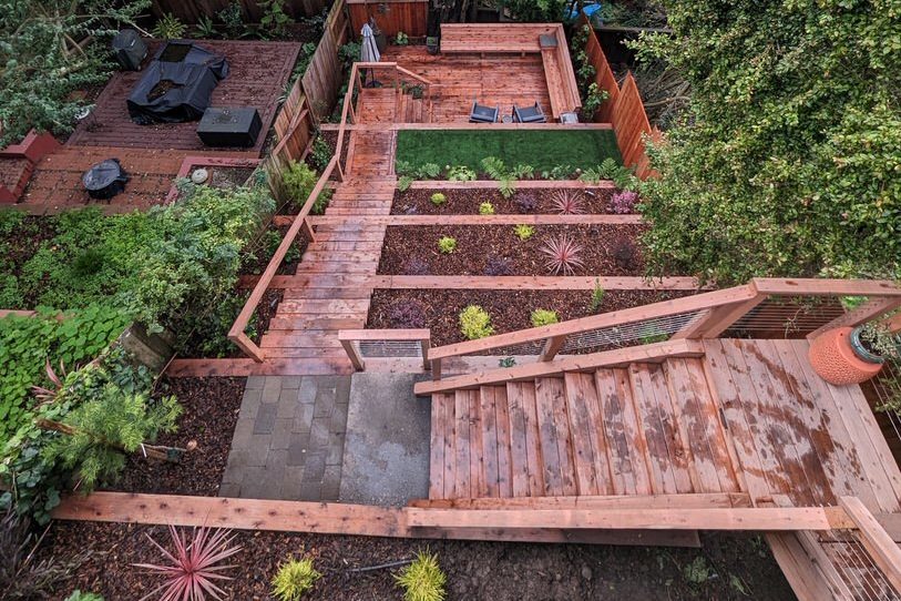 Ashbury Heights completed project aerial view with retaining walls, stairs, and deck.