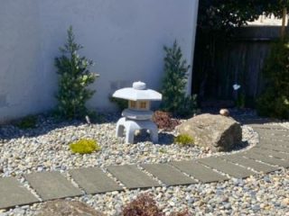 Asian style lantern in a rock garden, by Tamate Landscaping