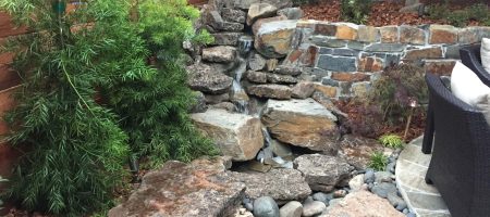 custom rock waterfall with a small recirculating water cascade in a boulder stream